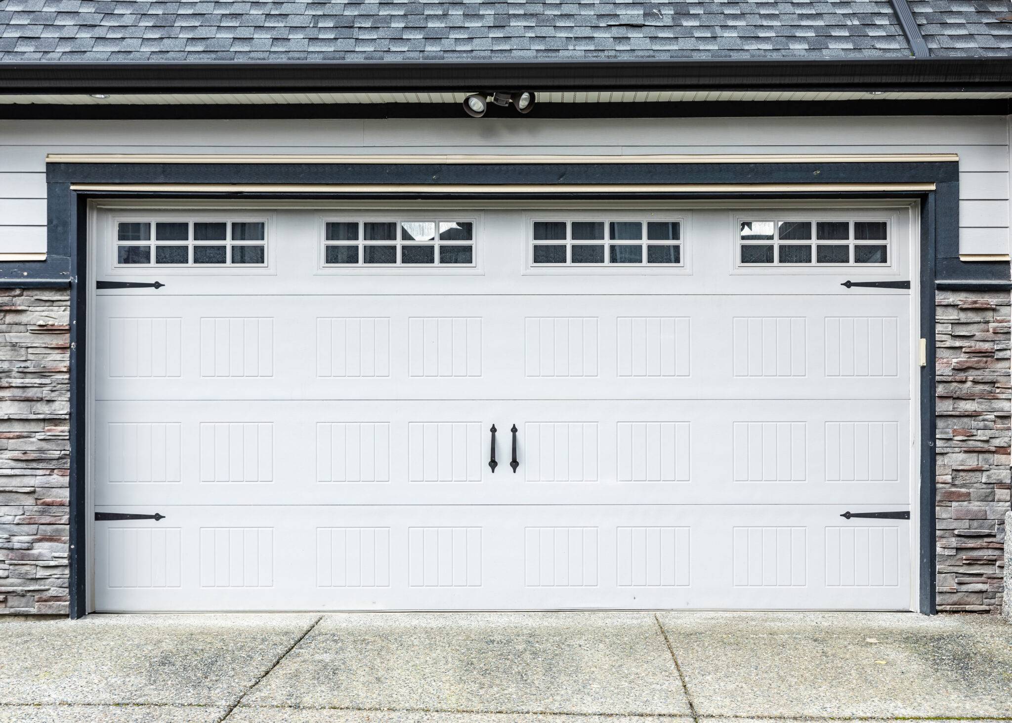 Garage Door. Modern House With Garage Door. Family House With Wide Garage Door And Concrete Driveway In Front.